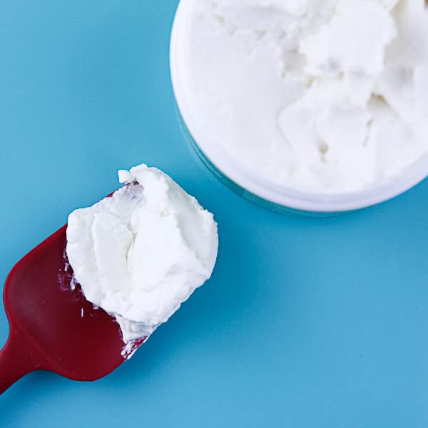 Hands applying Oyin Handmade Whipped Pudding demonstrates versatile hair and skin care