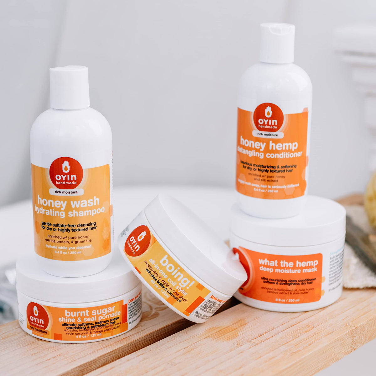 Applying Honey Hemp Detangling Conditioner on coils for easy detangling.