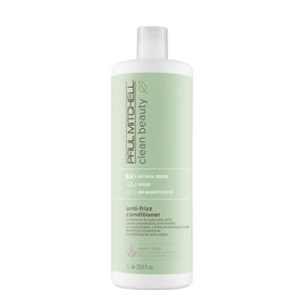 Paul Mitchell Clean Beauty Anti-Frizz Conditioner bottle pouring for smoother, frizz-free hair.