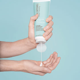 Close-up of Hydrate Conditioner on soft, manageable hair by Paul Mitchell Clean Beauty.