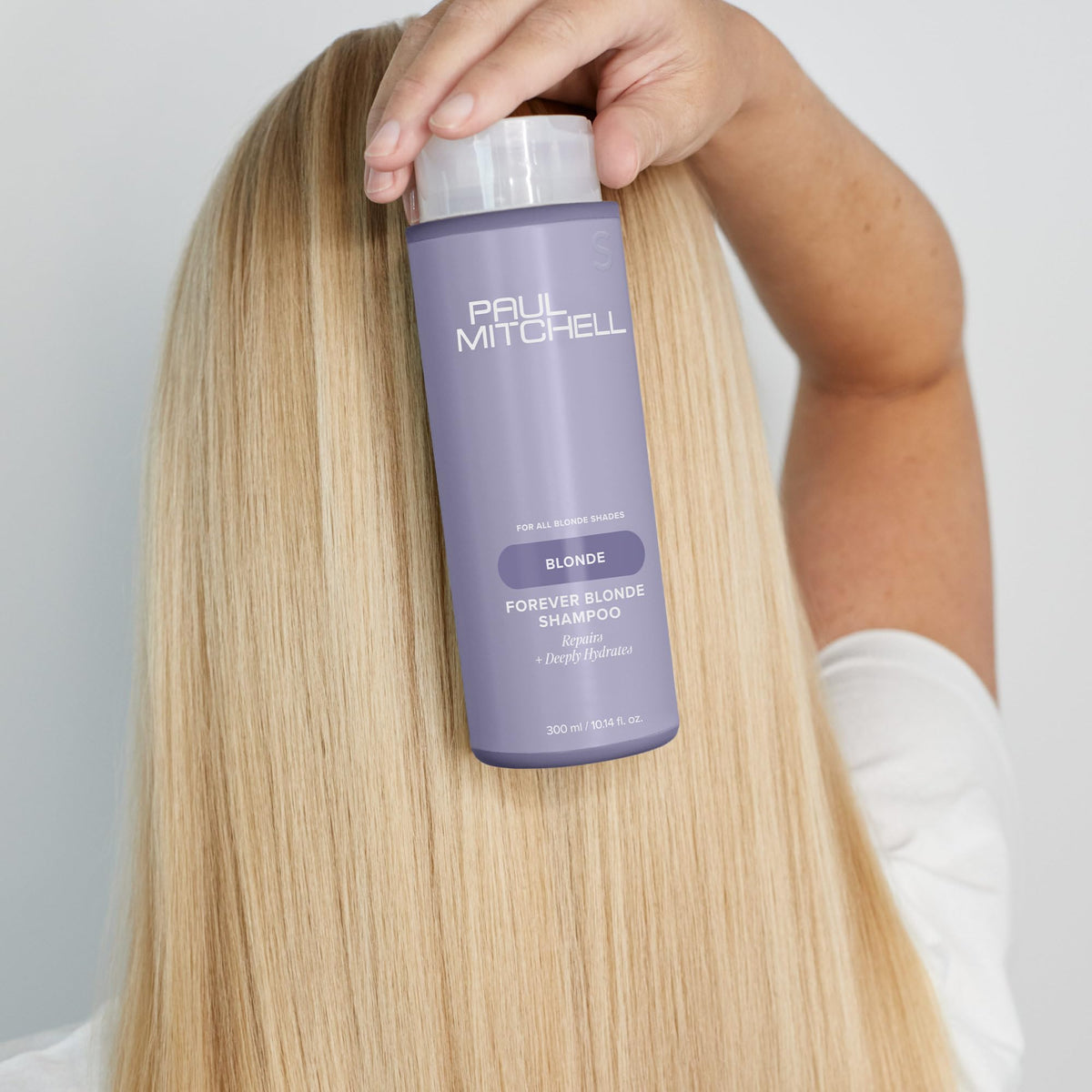 Paul Mitchell Forever Blonde Shampoo bottle pour demonstrating easy distribution