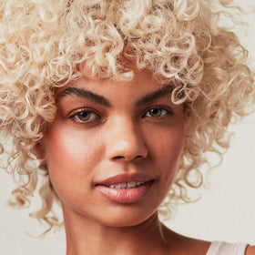 Paul Mitchell Platinum Blonde Violet Conditioner application on hair yields soft, shiny strands.