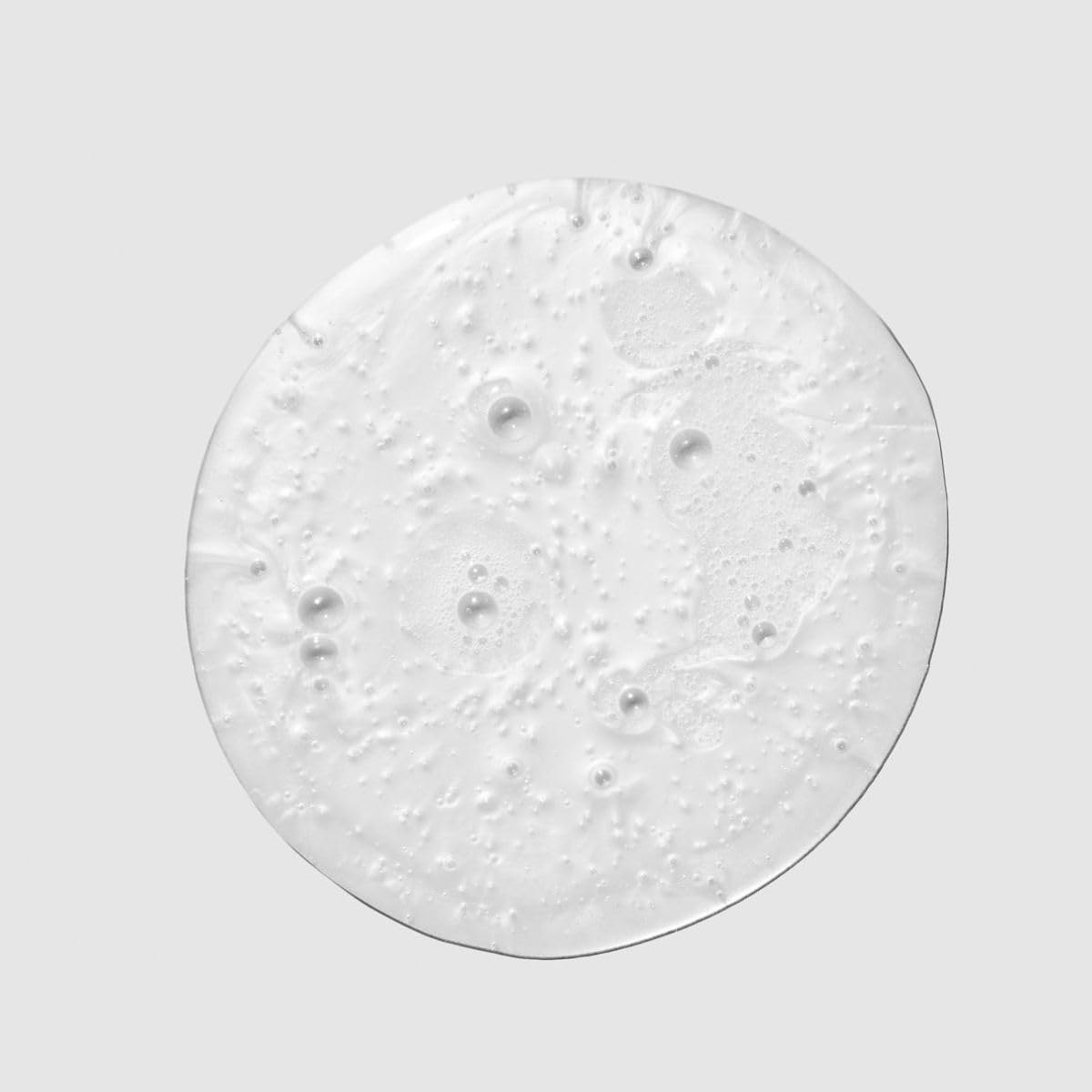Paul Mitchell Spring Loaded shampoo lather demonstrates rich cleansing foam for curls