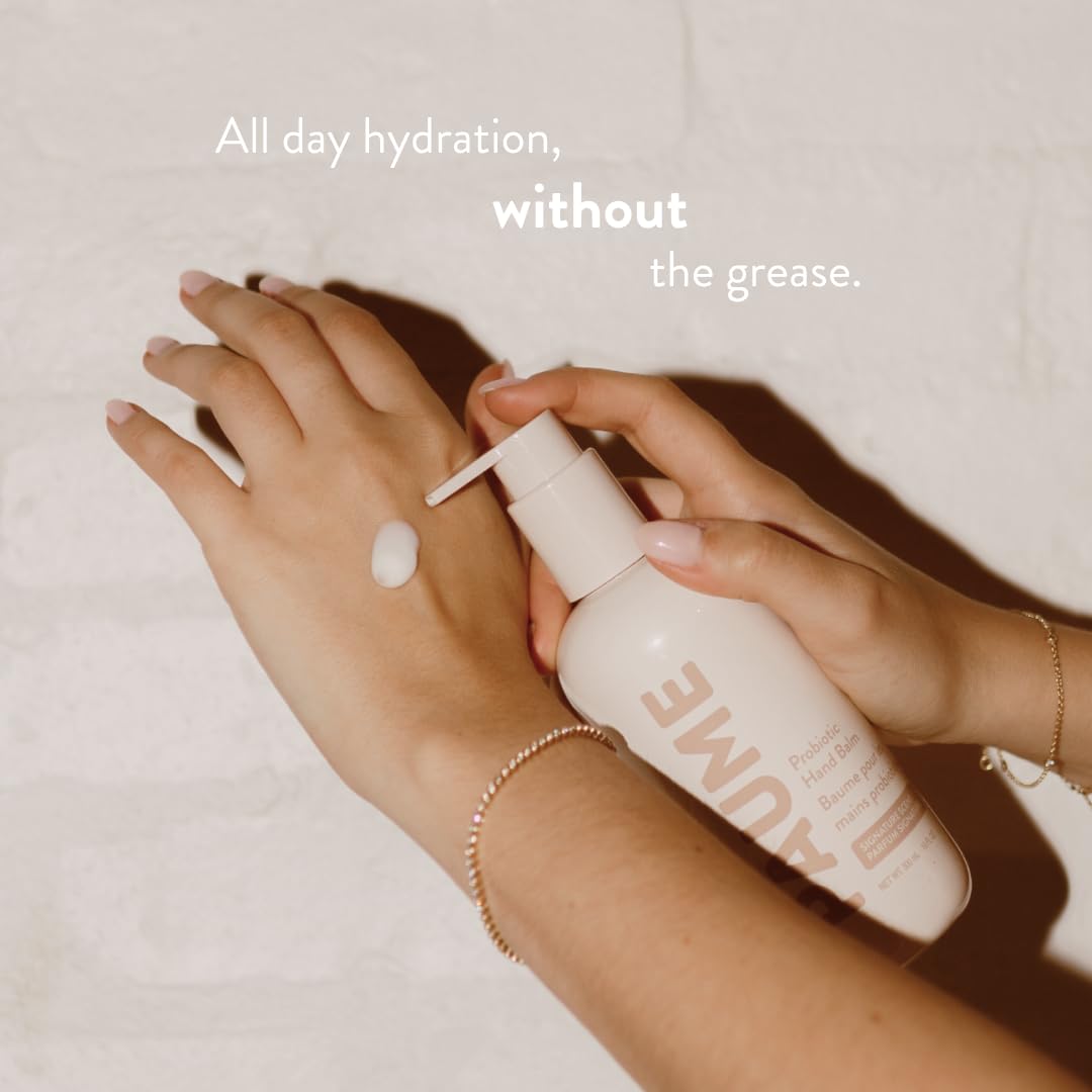 PAUME Probiotic Hand Balm being applied on a hand for fast-absorbing moisture.