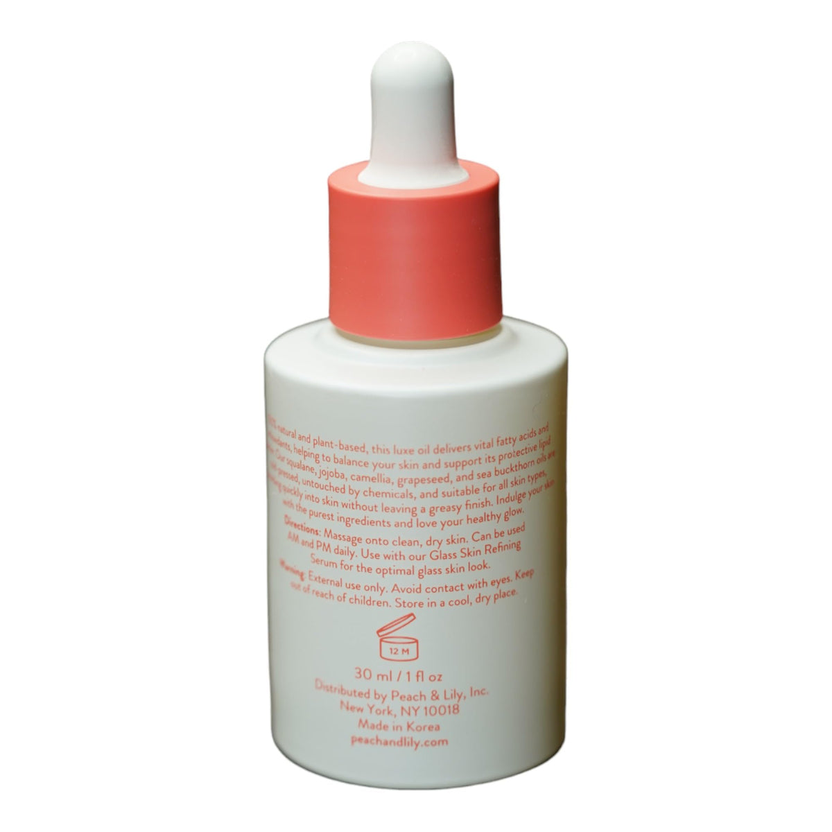 Peach & Lily Pure Beam Luxe Oil ingredients jar with sea buckthorn and jojoba