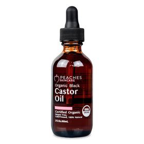 Peaches Skin Care black castor oil bottle highlighting skin hydration.