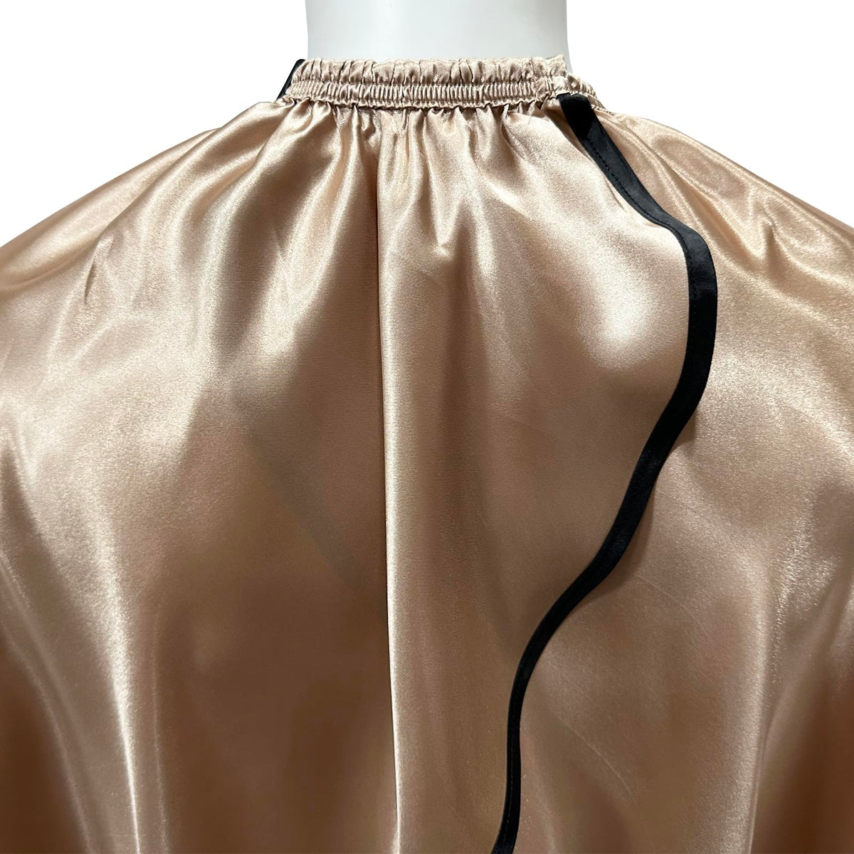 Pelocapa cape on model in champagne color highlighting full-coverage during styling.