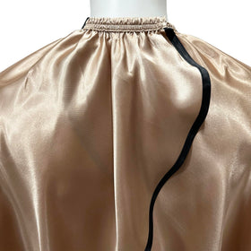 Pelocapa cape on model in champagne color highlighting full-coverage during styling.