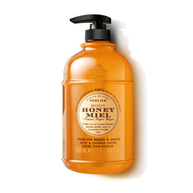 Perlier Honey Bath Cream bottle on a bathroom shelf suggesting silky skin benefits