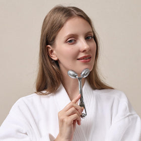 Pfefe facial roller being used on cheeks for smooth, lifted feeling.