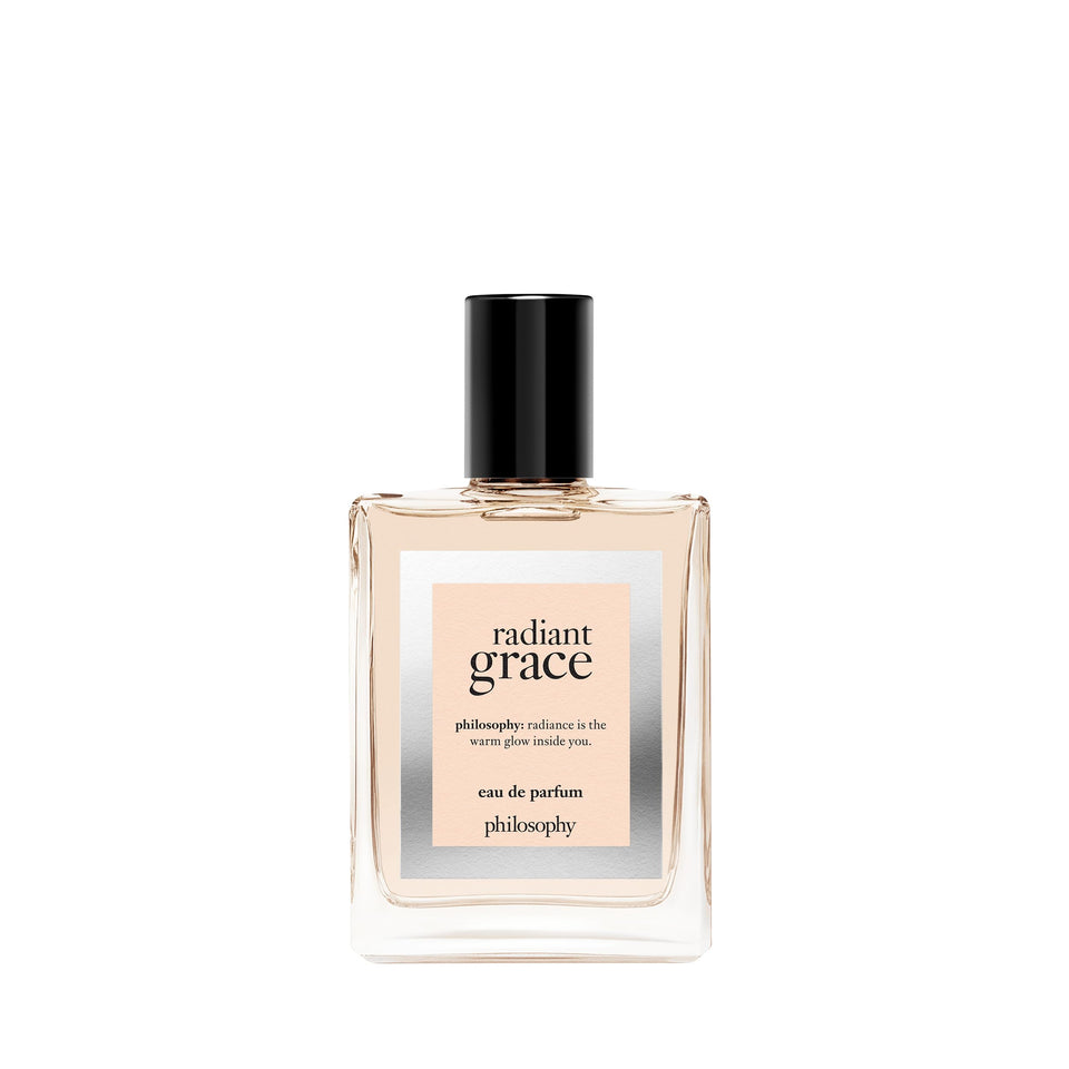 Philosophy Radiant Grace bottle close-up showing warm ambery tones for everyday confidence.