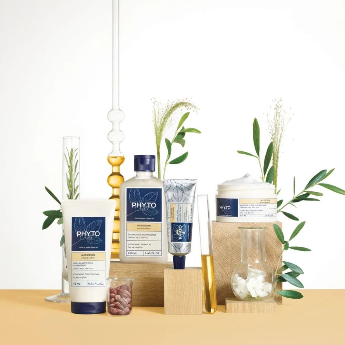 Close-up of PHYTO NOURISHMENT formula clinging to hair shafts.
