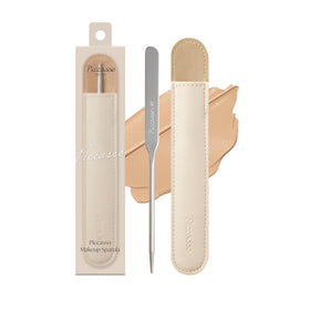 Piccasso foundation spatula applying a thin, precise base for flawless skin.