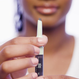 Pixi Natural Brow Duo gel brush through brows for shaping and control.
