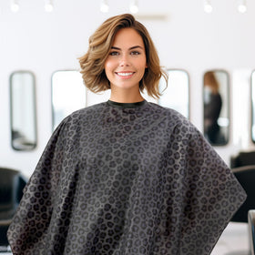 Plum Hill leopard-print cape draped on model emphasizes stylish salon protection