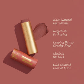 Poppy & Pout Debbie lip tint tube held by hand showing size and application.
