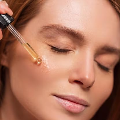 Application close-up of Progestelle Body Oil being gently spread on skin.