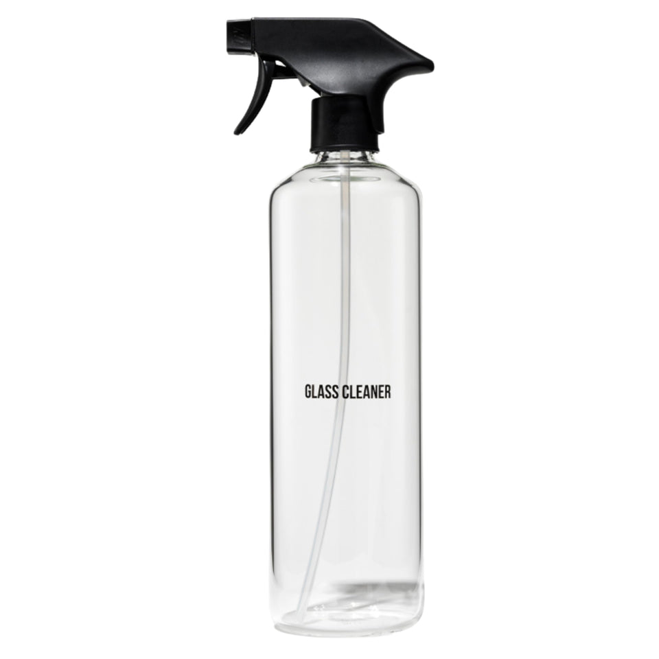 Public Goods empty glass spray bottle top view, minimalist design for quick cleaning tasks.