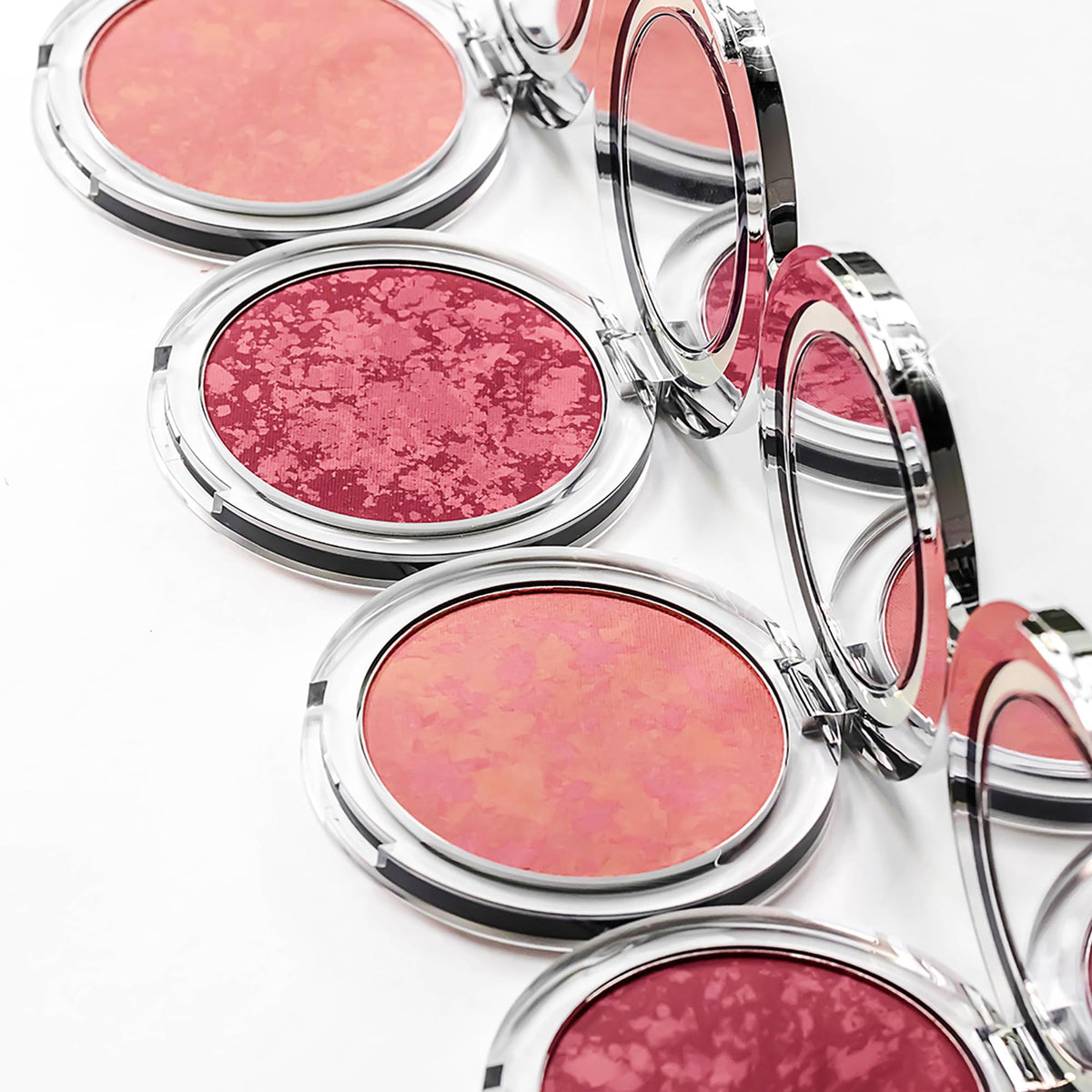 Close-up of applying PÜR MINERALS Blushing Act with a brush for blending