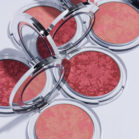 Peach swatch on skin from PÜR MINERALS Blushing Act for soft color