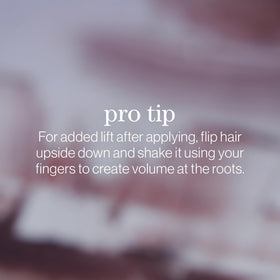Styled hair using Pureology Texture Finishing Spray for lightweight body and movement.