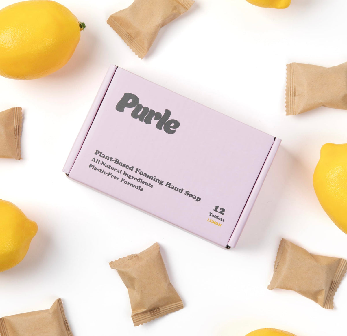 Purle refill tablet dissolving in water to create lemon-scented foam.