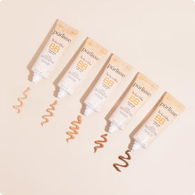 Purlisse BB Cream being applied with fingers for easy blending.