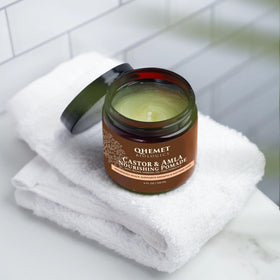 Qhemet Biologics pomade jar close-up shows creamy texture for easy detangling