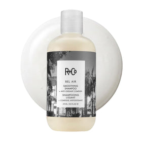 R+Co Bel Air smoothing shampoo bottle pouring for lightweight cleanse and fragrance