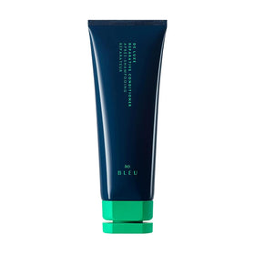 R+Co BLEU De Luxe bottle front shows rich hydration for damaged hair.