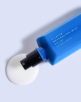 R+Co BLEU F-Layer Detangling Mist pump bottle showing lightweight hydration for manageability.