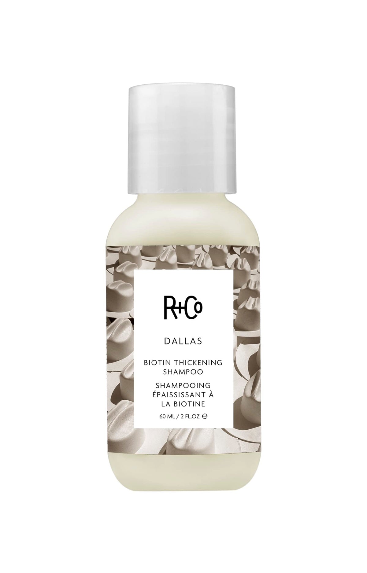 R+Co Dallas Thickening Shampoo bottle on bathroom counter boosts volume for fine hair