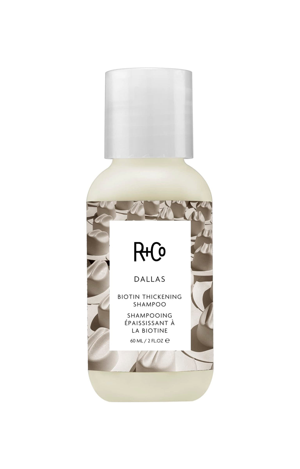 R+Co Dallas Thickening Shampoo bottle on bathroom counter boosts volume for fine hair