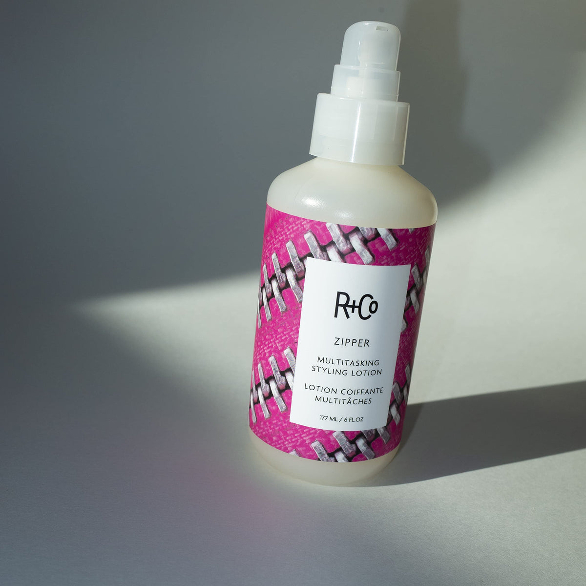 R+Co Zipper application shows easy damp-hair use before blow-drying.