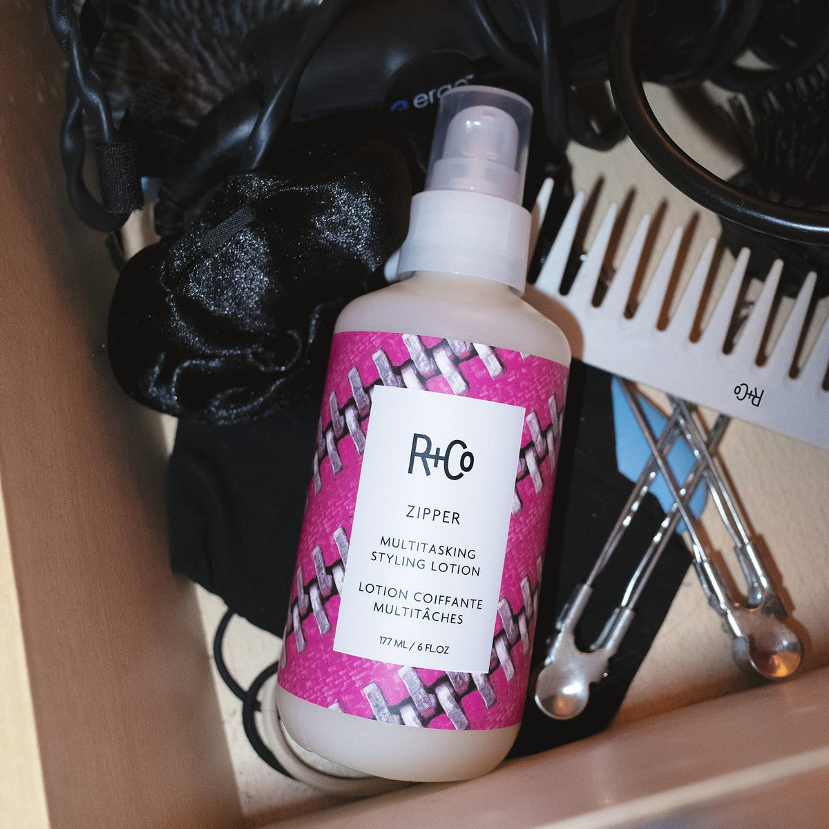 R+Co Zipper styling lotion boosts smoothness and texture for any style.