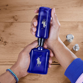 Polo Blue bottle in spray action demonstrating quick fragrance refresh