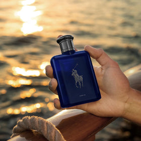 Ralph Lauren Polo Blue bottle silhouette against navy backdrop.