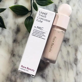 Rare Beauty concealer swatch 140C shows brightening under-eye coverage