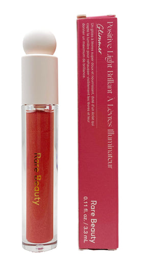 Rare Beauty Glimmer lip gloss bottle displaying rose gold shimmer and hydration