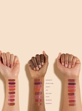 Rare Beauty Lip Oil Delight during application highlights glossy texture and moisturizing feel
