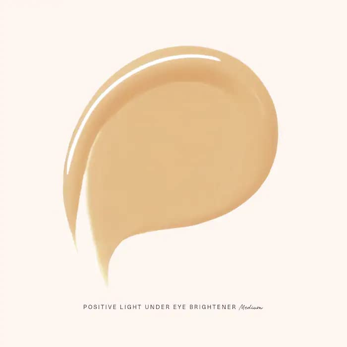 Rare Beauty Under Eye Brightener Cream texture closeup shows light, smooth finish.