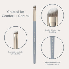 Close-up of Ravie Beauty brush along the lash line for natural edge control