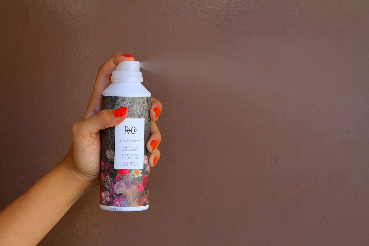 R+Co Centerpiece spray mist showing smooth frizz control.