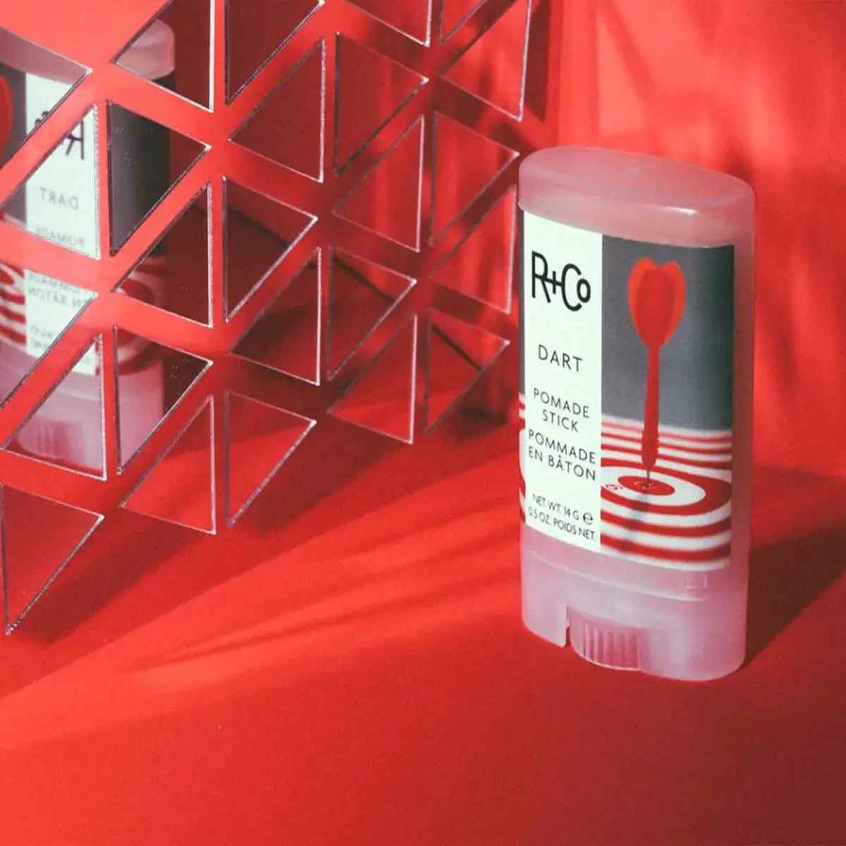 R+Co Dart Pomade Stick on hair showing sleek, controlled styling.
