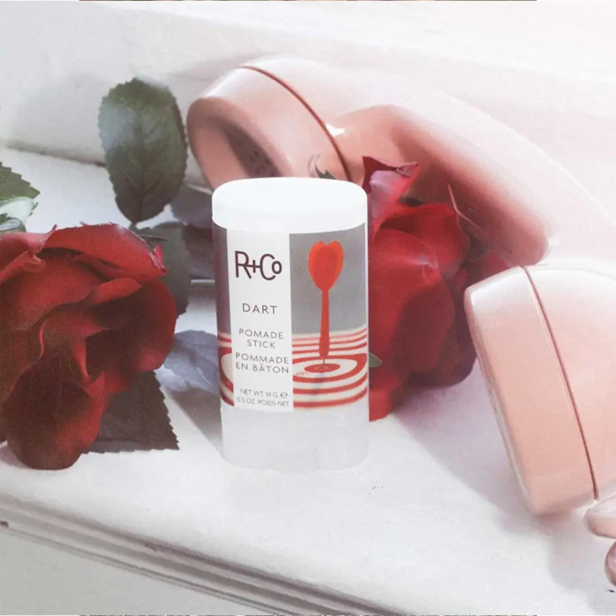 R+Co Dart Pomade Stick adds a glossy, polished finish to styled hair.