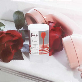 R+Co Dart Pomade Stick adds a glossy, polished finish to styled hair.