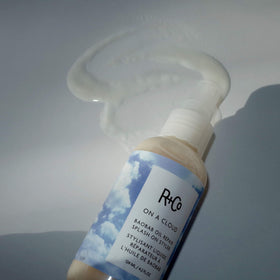 R+Co On A Cloud Baobab Oil Repair Splash packaging shot shows premium styling solution