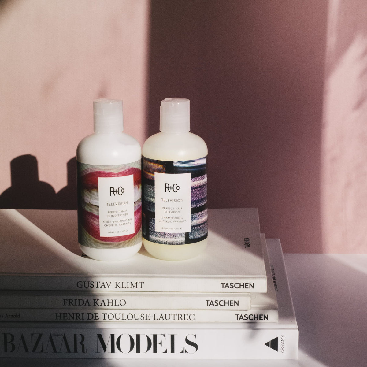 R+Co Television Perfect Hair Shampoo on wet hair for even distribution.