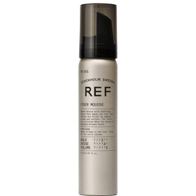 REF 345 Fiber Mousse being massaged between hands to activate fibers for fuller styling.