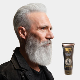 Hands applying REUZEL beard wash for a clean, soft, hydrated beard.